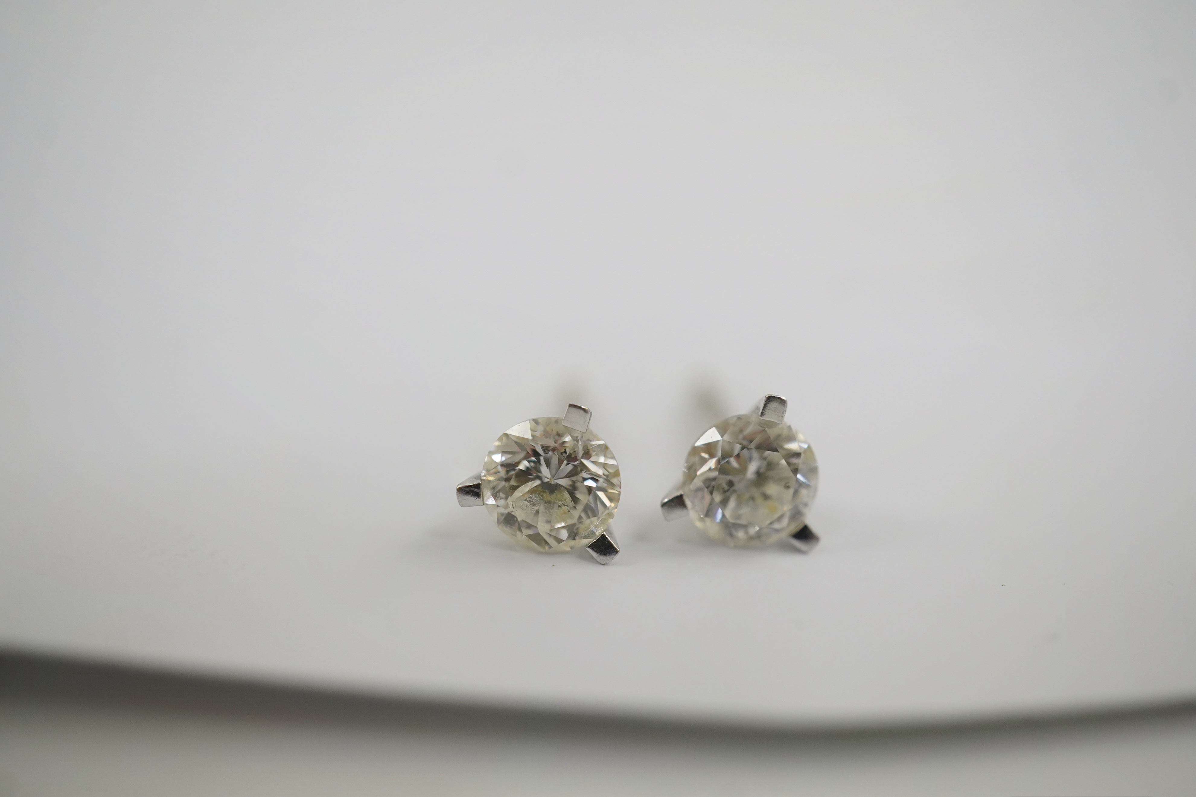A modern pair of 18ct white gold and solitaire diamond set ear studs